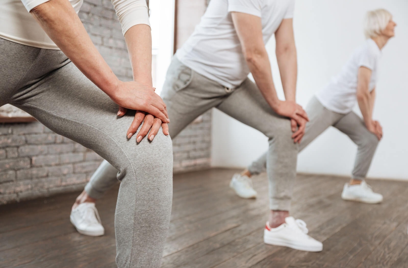A group of seniors stretch in an exercise group at their senior living community.
